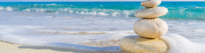 stones balanced on each other in beach setting